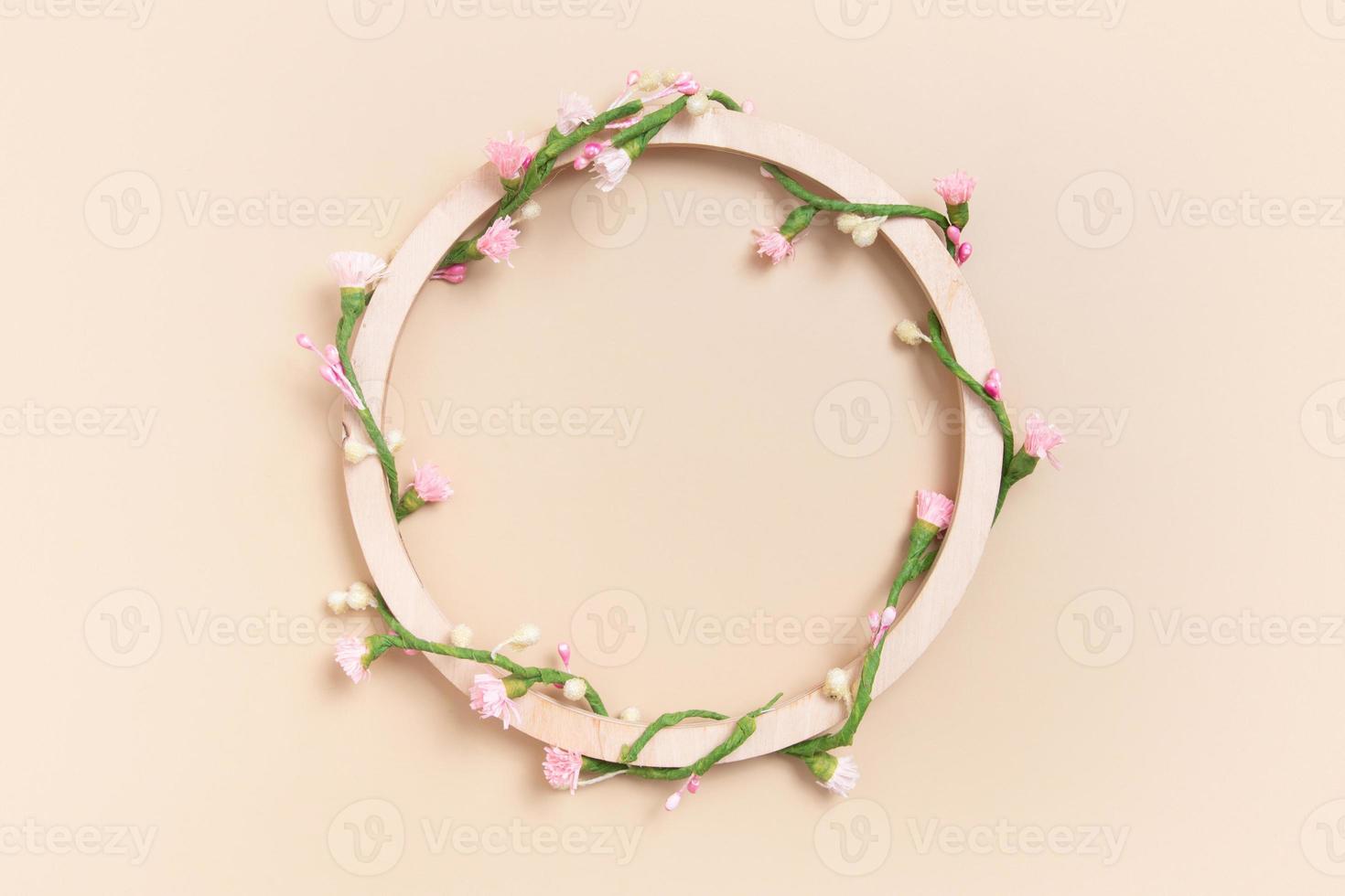 Round wooden frame with copy space decorated with floral pattern photo