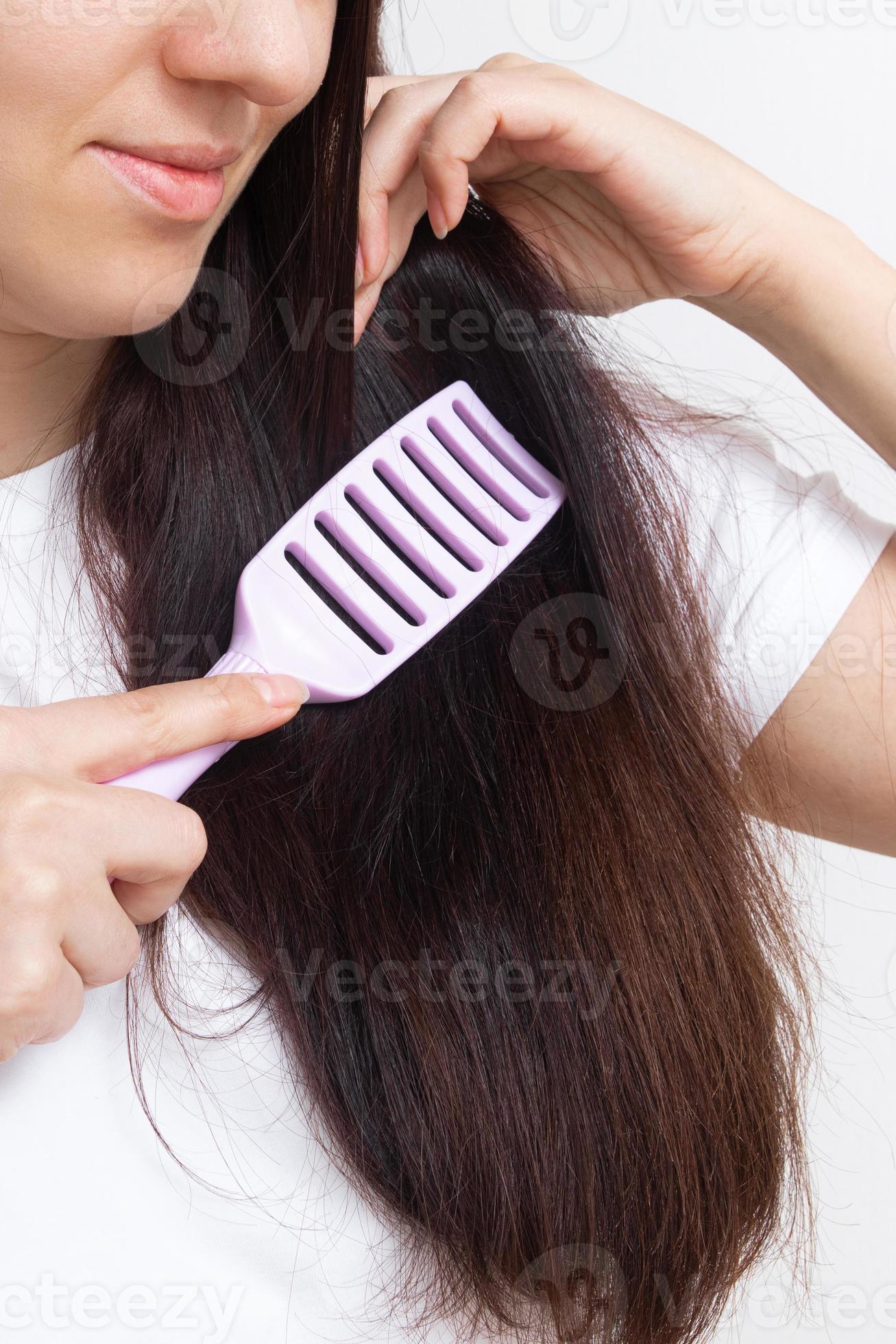 Girl combing tangled, brittle, split ends, care for long hair concept