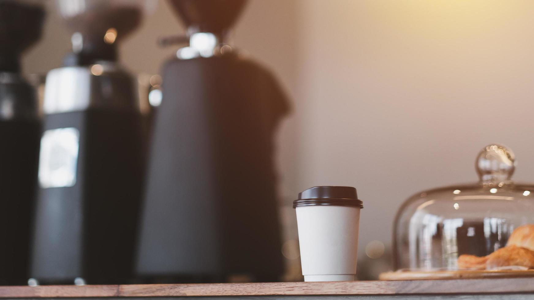 Hot coffee to go on the table in the Coffee shop. Paper cup of hot coffee. Takeaway. photo