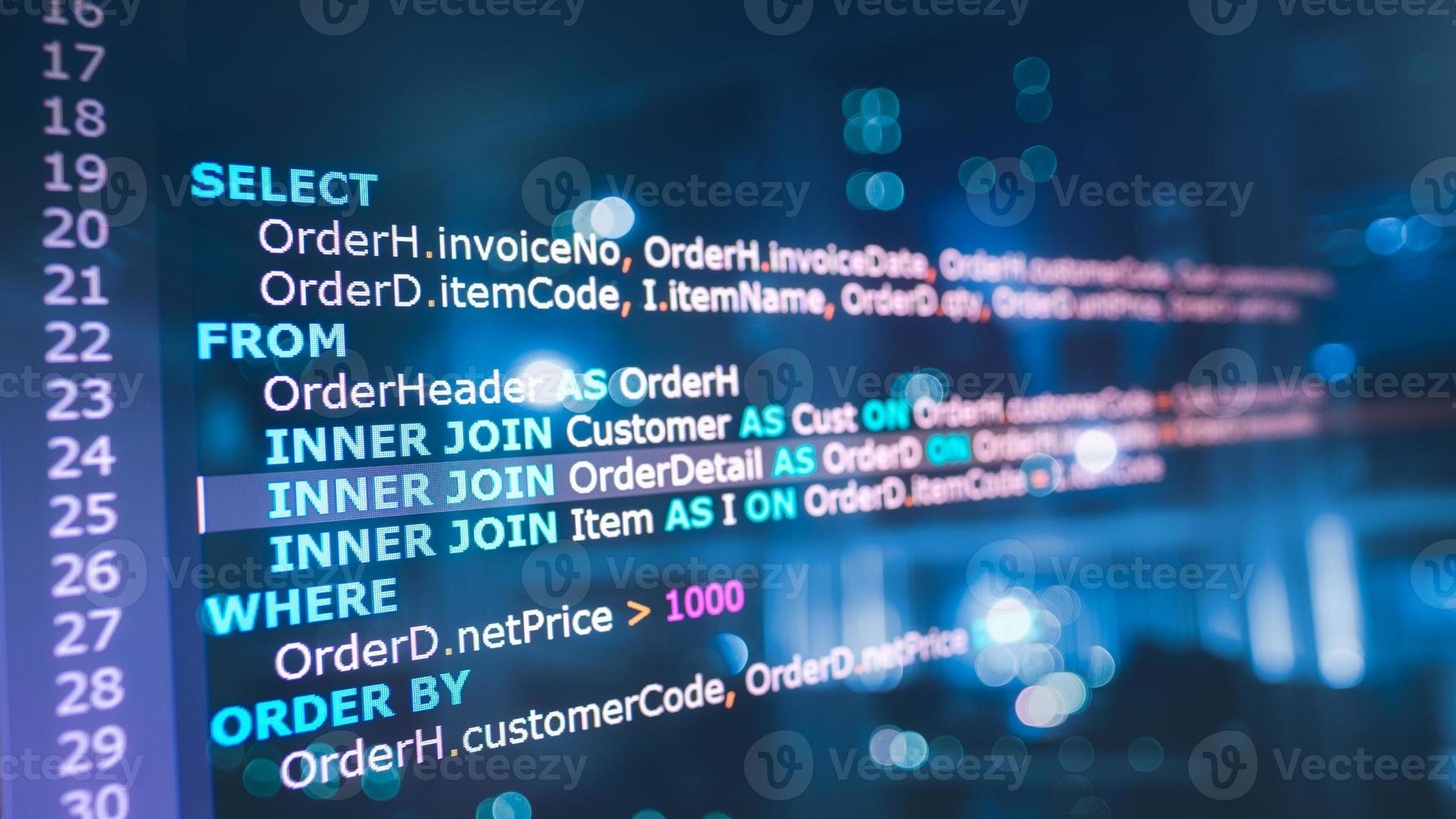SQL or Structured Query Language code on computer monitor and server room background. Example of SQL code to query data from a database. photo