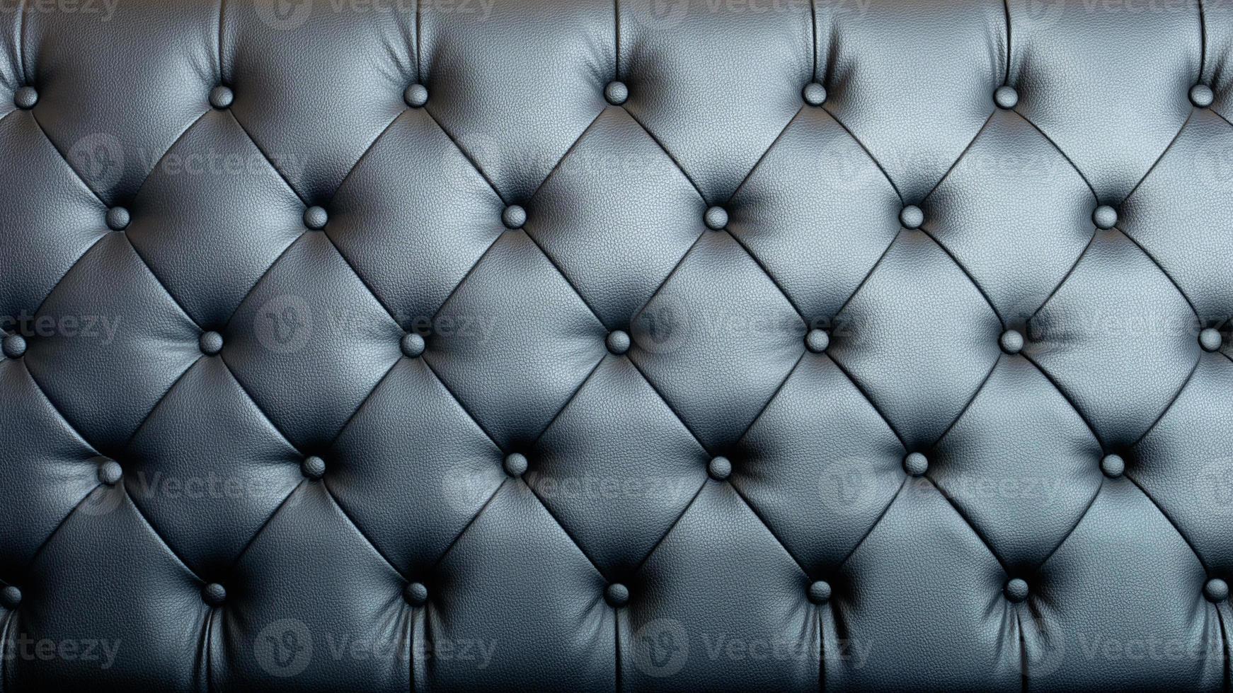 Black artificial leather sofa with rivets texture for background. photo