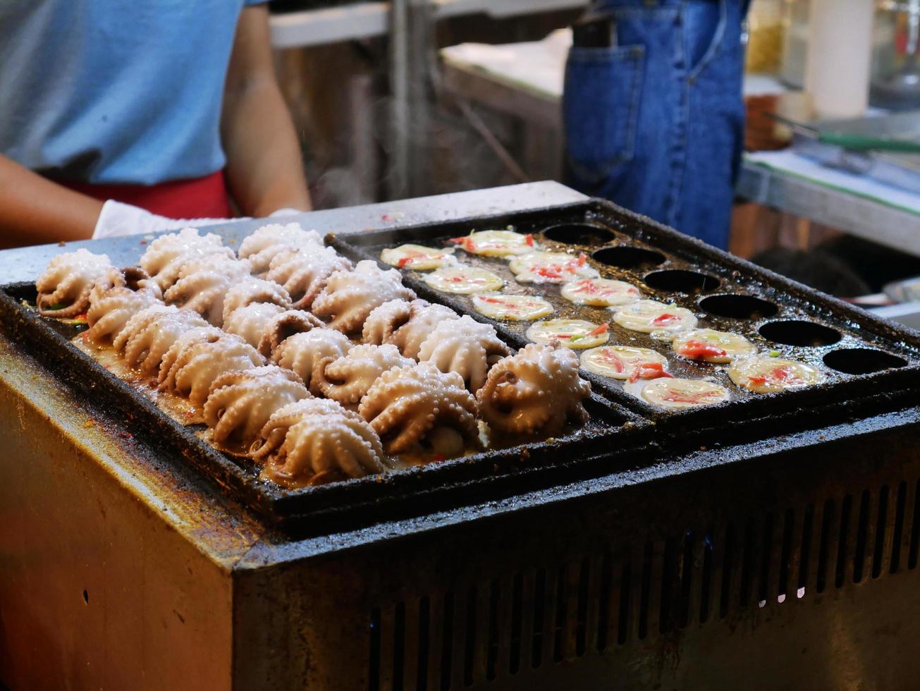 Fresh grilled squid on charcoal grill,Roast octopus on white plate.Seafood on street food,Thailand. photo