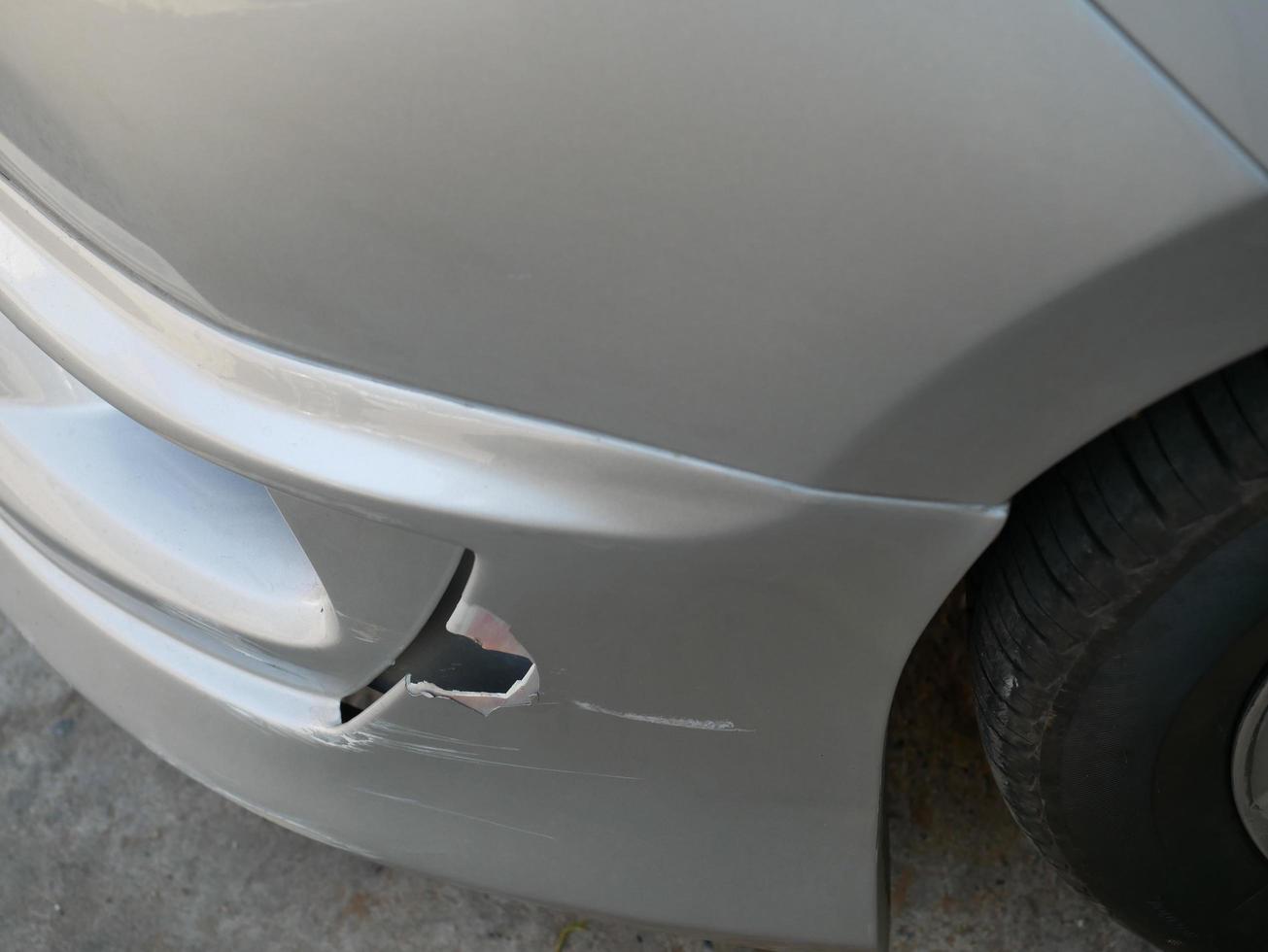 Scratches on the car after an accident damage to the front bumper. photo