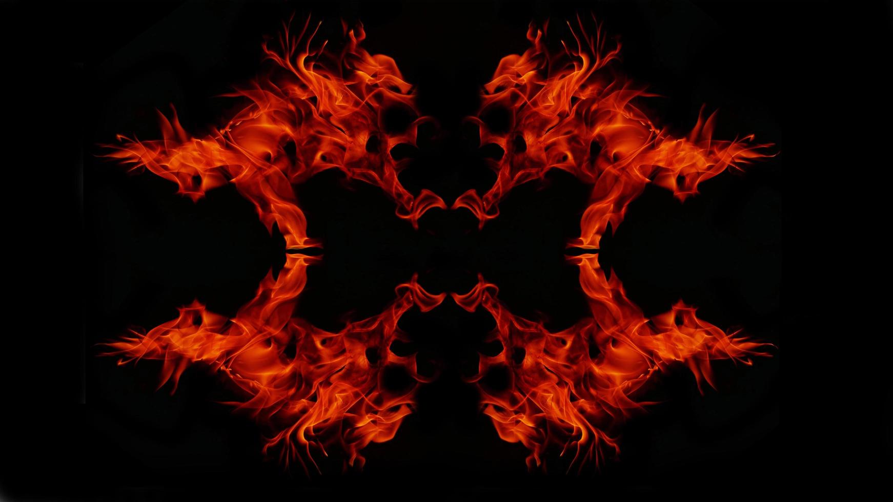 A beautiful flame shaped as imagined. like from hell, showing a dangerous and fiery fervor, black background photo