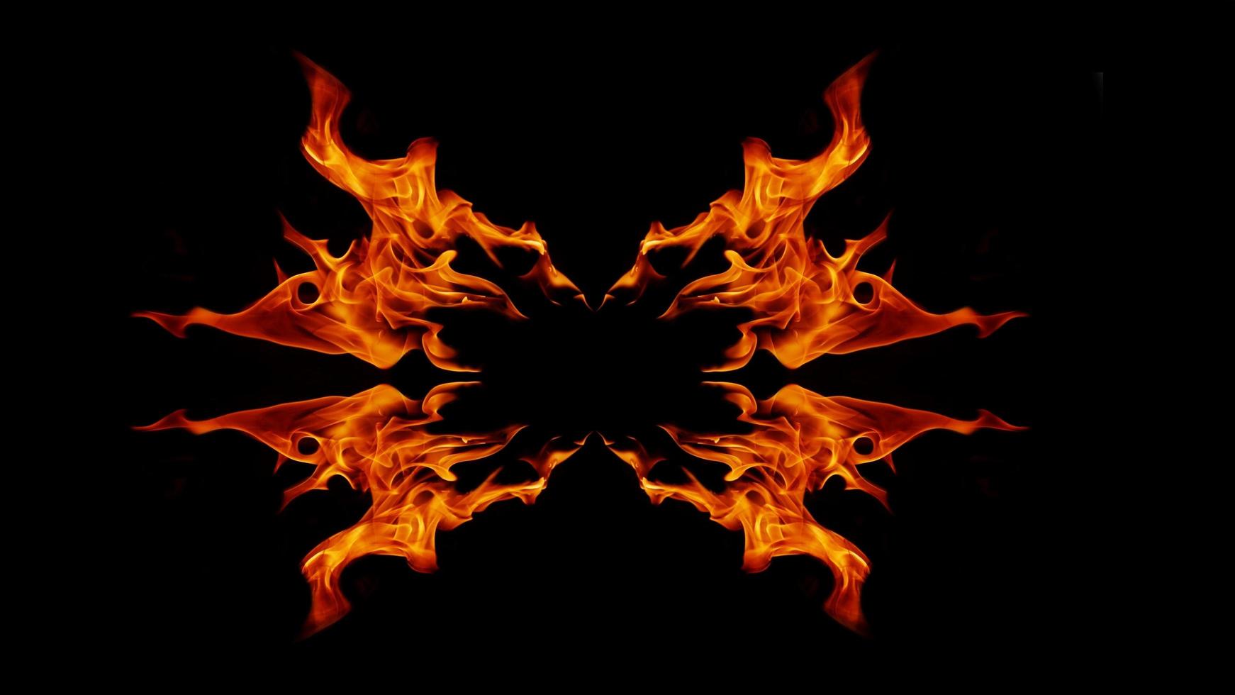 A beautiful flame shaped as imagined. like from hell, showing a dangerous and fiery fervor, black background photo