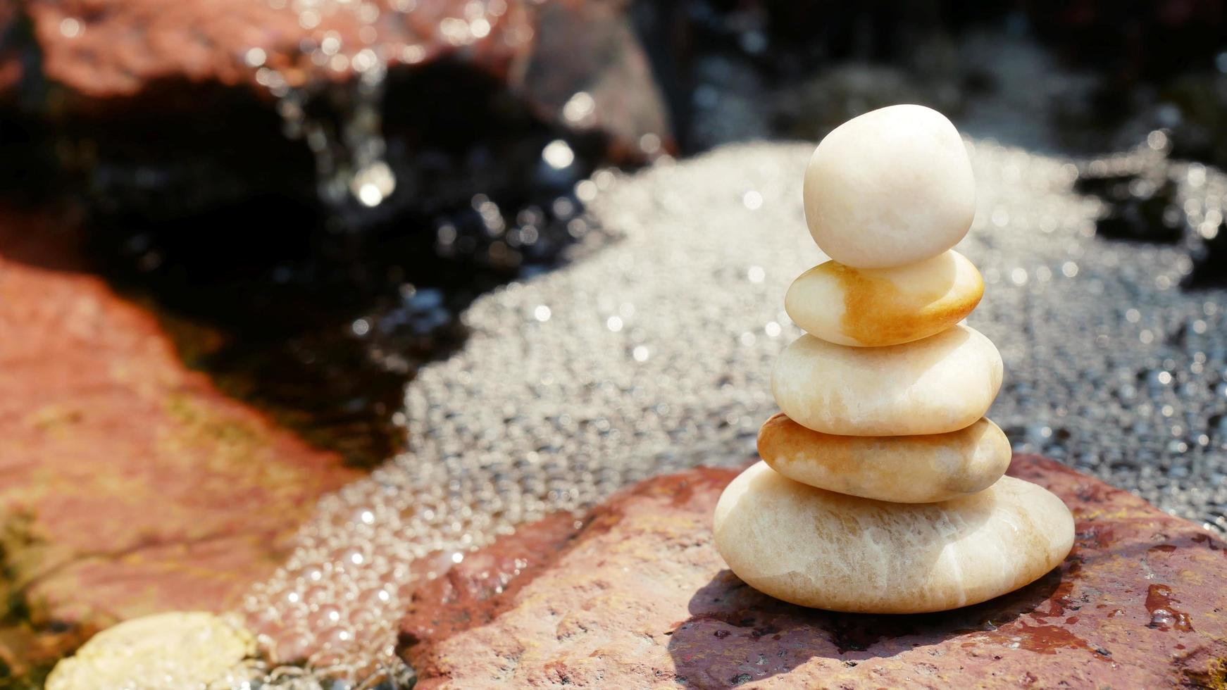 The Balance Stones are stacked as pyramids in a soft natural bokeh background, representing the calm philosophical concept of Jainism's wellness. photo