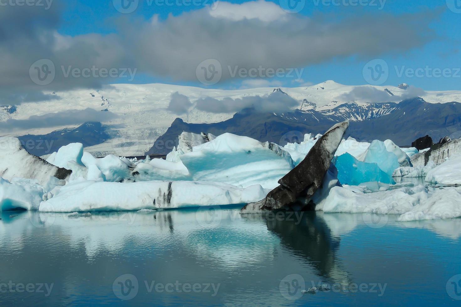 Bright clear blue iceberg floating in the Jokulsarlon lake blue cold water in Iceland 47 photo