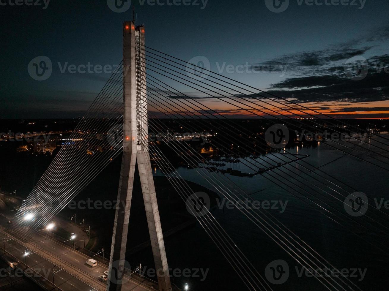 Aerial panoramic view of the Riga bridge across river Daugava at night. Cable-stayed bridge in Riga, Latvia at night. photo