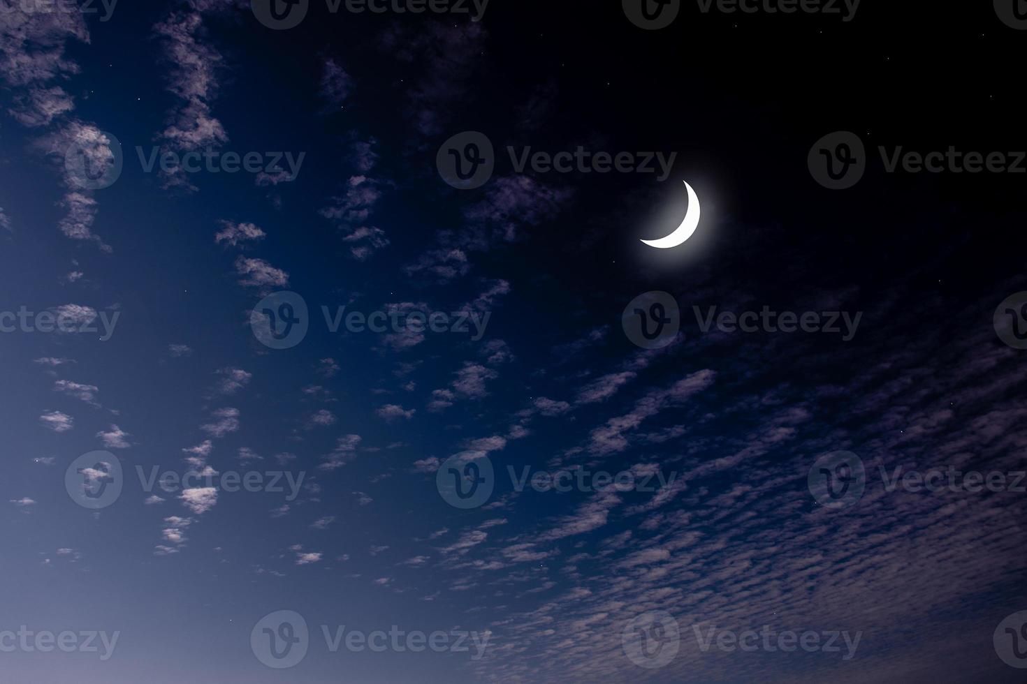 See the Islamic moon in the night sky. Evening sky and the vastness in the dark are beautiful twinkling stars. The crescent moon concept, the symbol of Islam, begins the month of Ramadan, eid al fitr photo