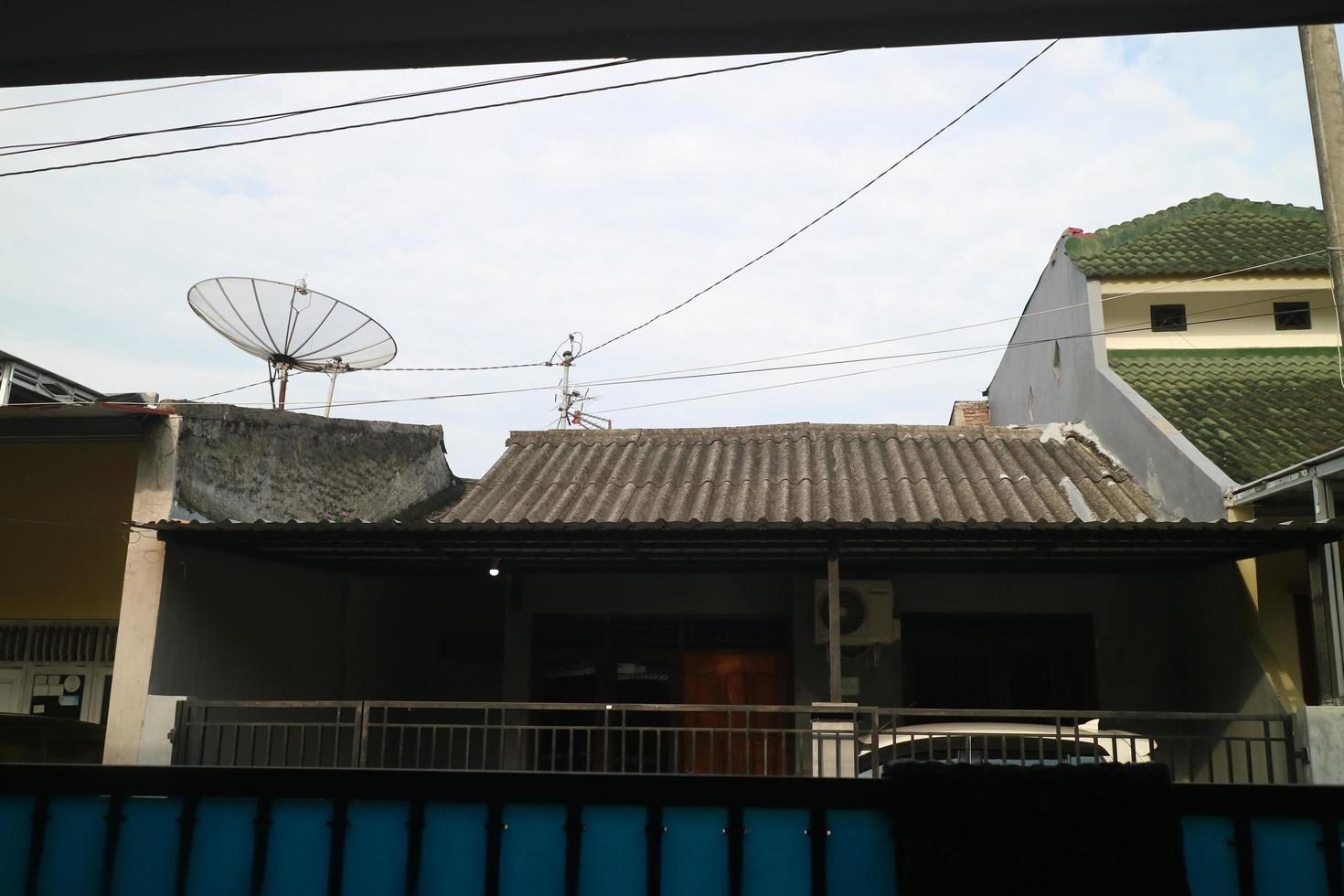 a photo of the house with a gray tile and a large satellite dish on it