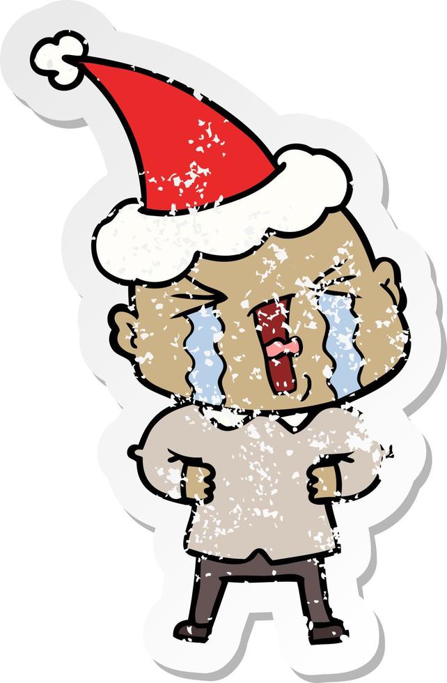 distressed sticker cartoon of a crying bald man wearing santa hat vector