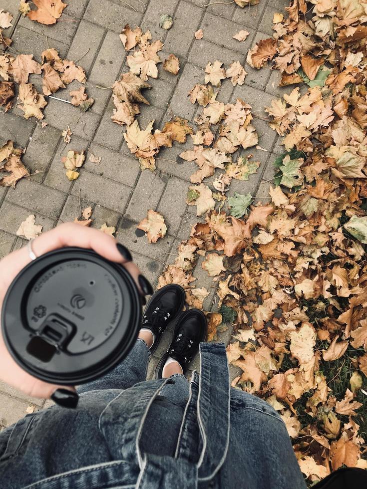 Cup of coffee in hand. Autumn warm cozy photo