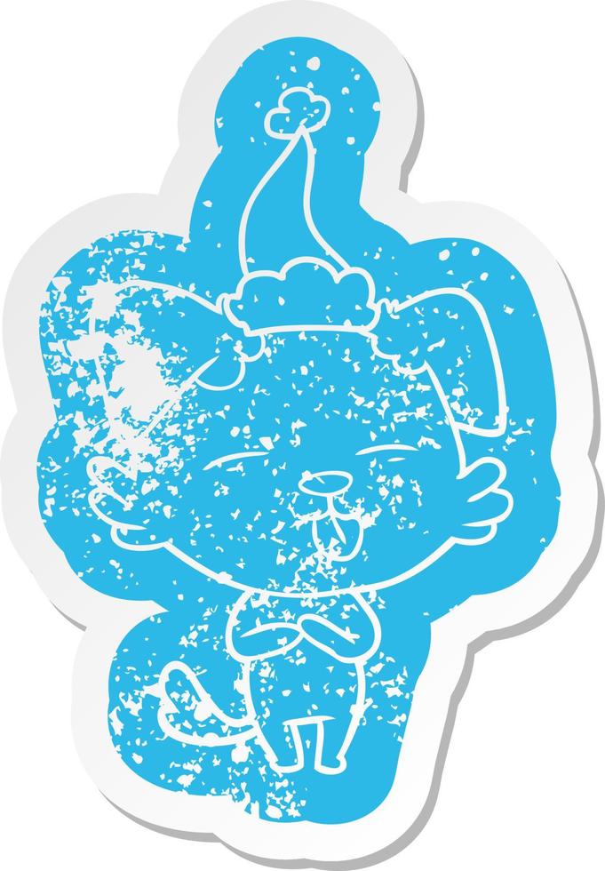cartoon distressed sticker of a dog sticking out tongue wearing santa hat vector