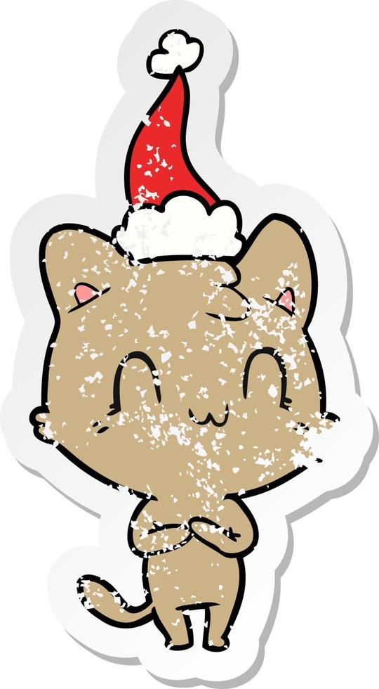 distressed sticker cartoon of a happy cat wearing santa hat vector