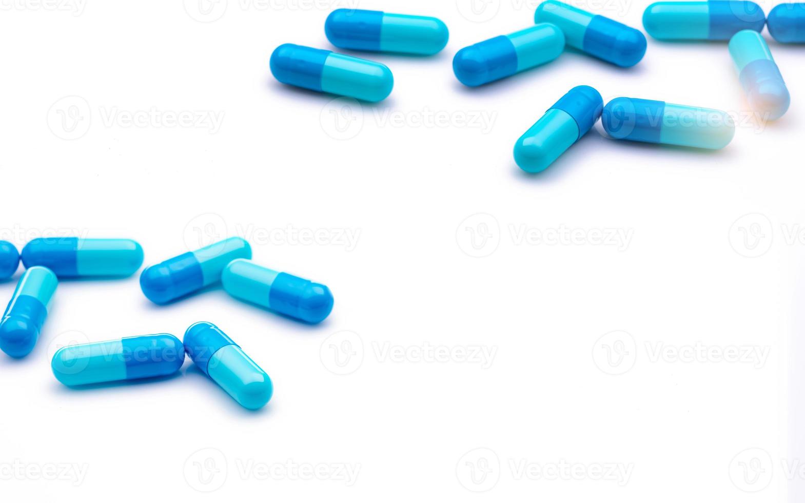 Blue antibiotic capsule pills on white background. Prescription drugs. Antibiotic drug resistance. Antimicrobial capsule pills. Pharmaceutical industry. Healthcare and medicine. Pharmacy product. photo