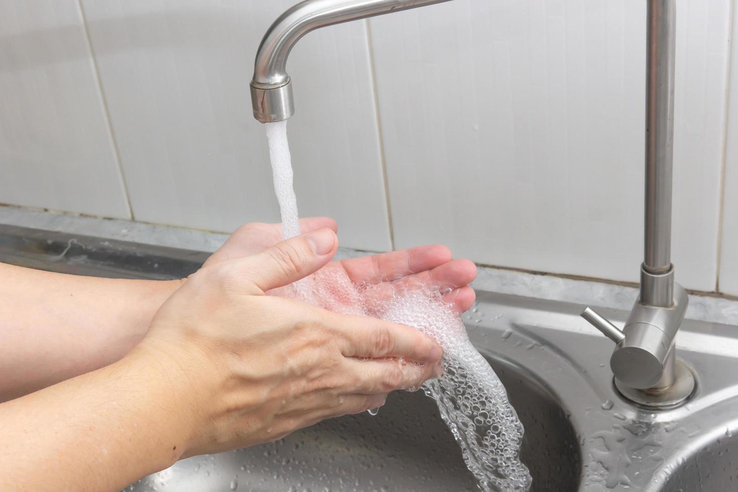 Both hands are washing their hands in the sink. Hygiene concept. photo