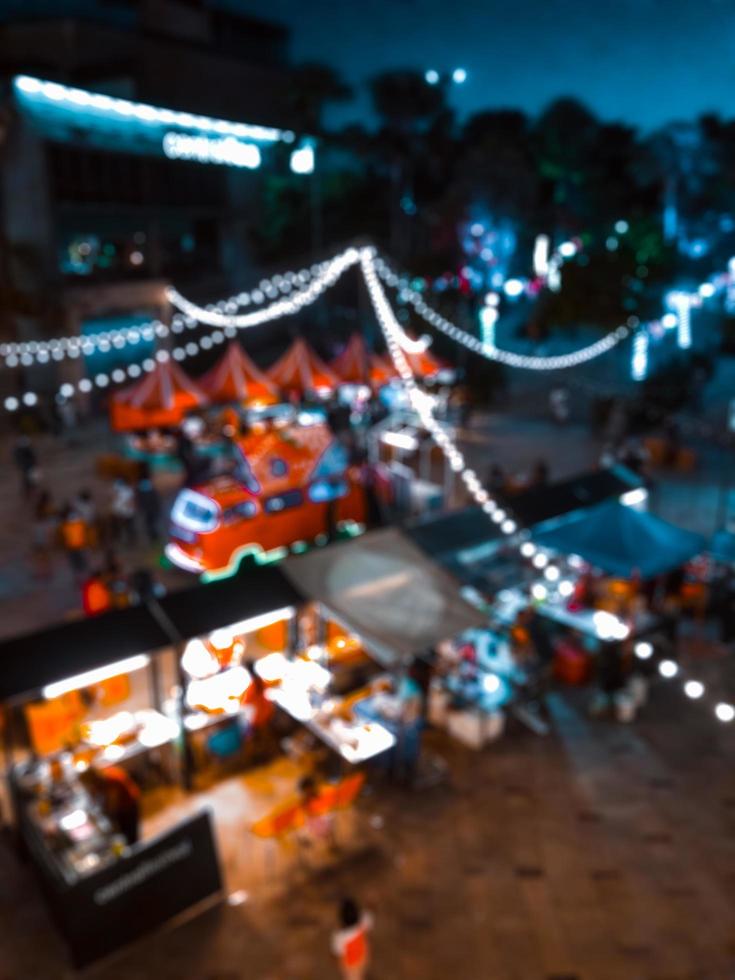 Blurred images of thailand night streets food party in city, bokeh light,festival background. photo