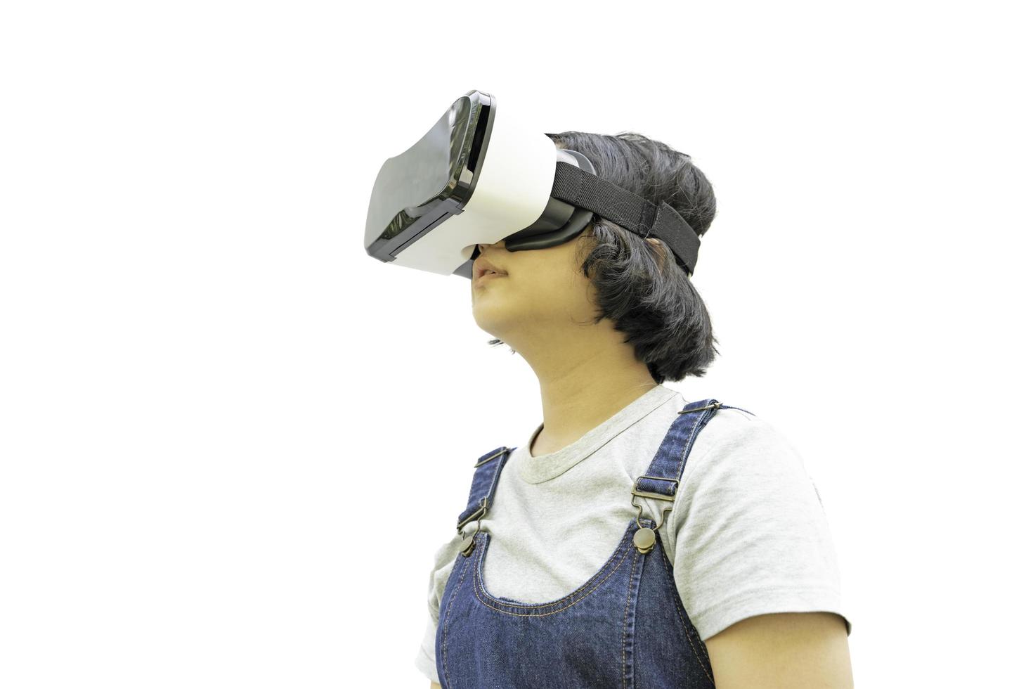 Asian girls are excited about the VR experience alone on white,  online education, education, gadgets, technology, and video game concepts. photo