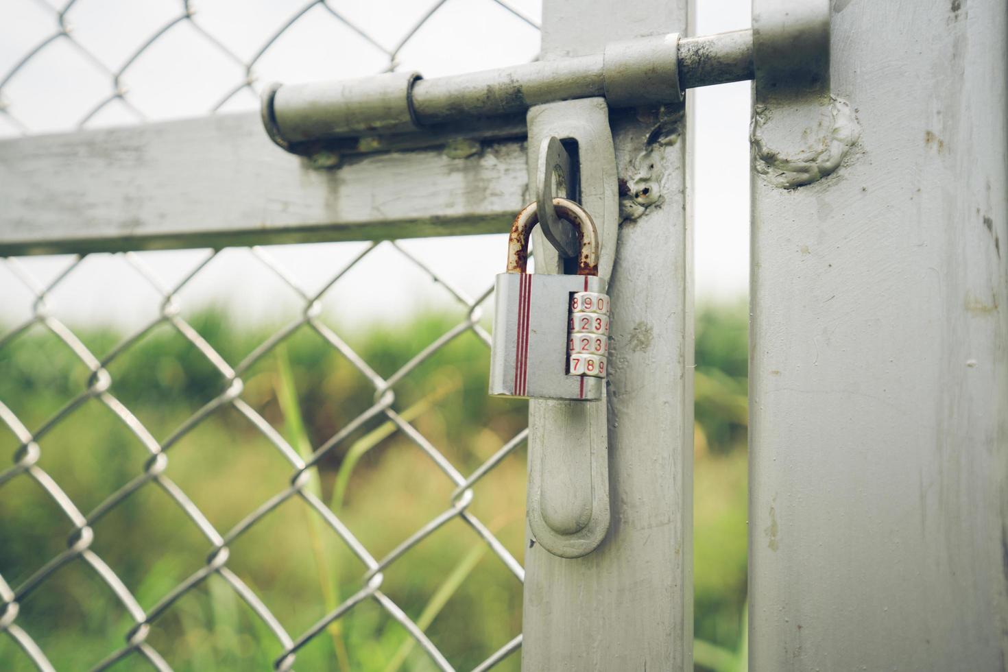 Number padlock on the iron door.soft focus. photo