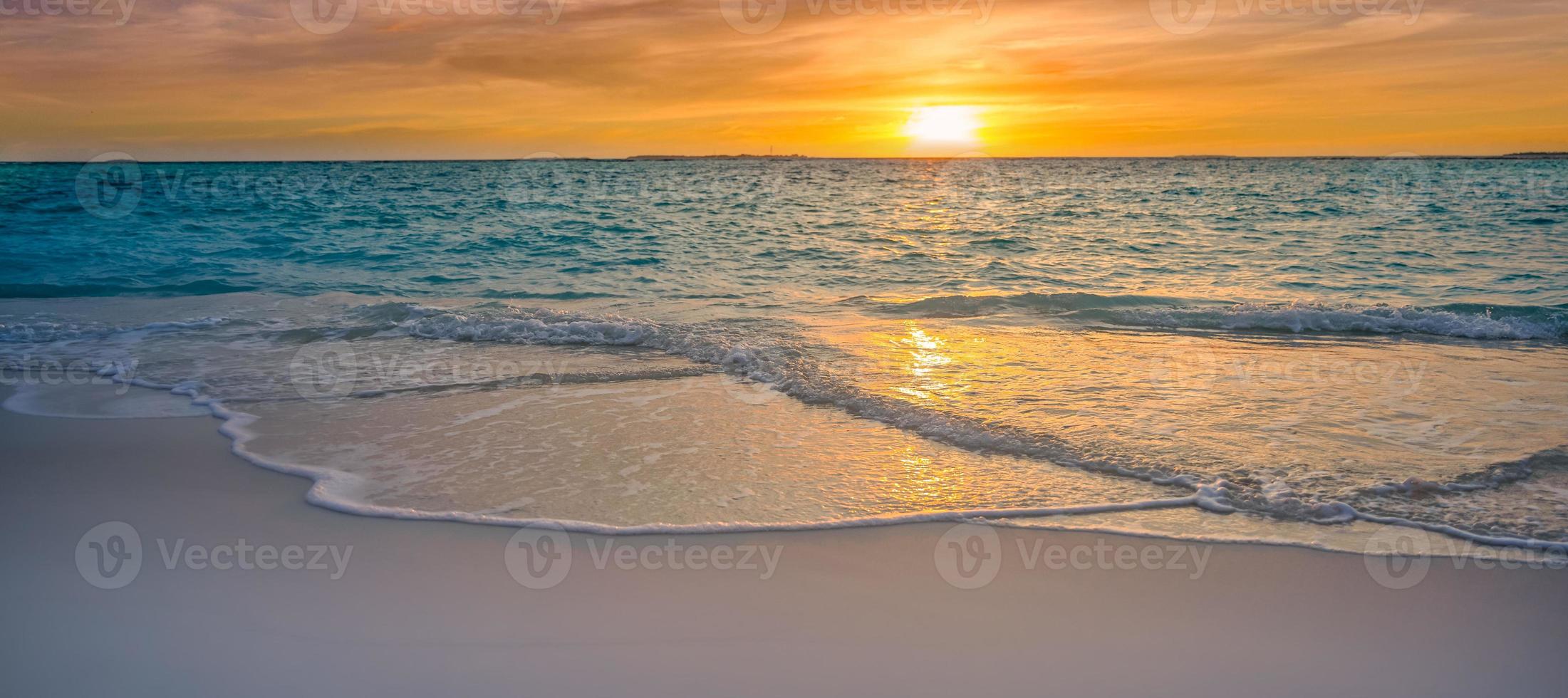 Closeup sea sand beach. Panoramic beach landscape. Inspire tropical beach seascape horizon. Orange and golden sunset sky calmness tranquil relaxing sunlight summer mood. Vacation travel holiday banner photo