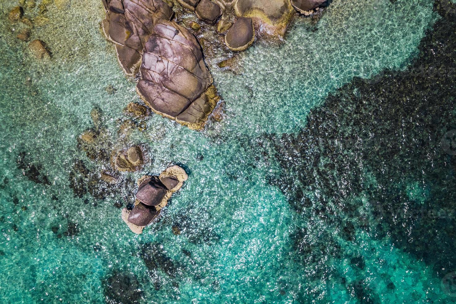 Crystal clear blue water at tropical island, bird's eye view photo