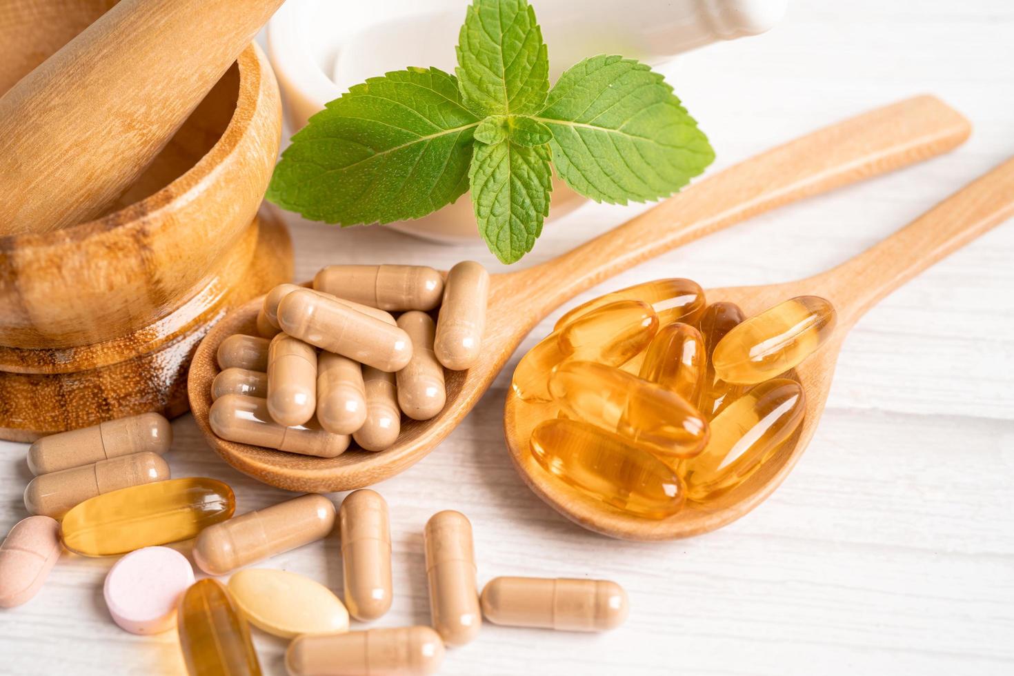 Alternative medicine herbal organic capsule with vitamin E omega 3 fish oil, mineral, drug with herbs leaf natural supplements for healthy good life. photo