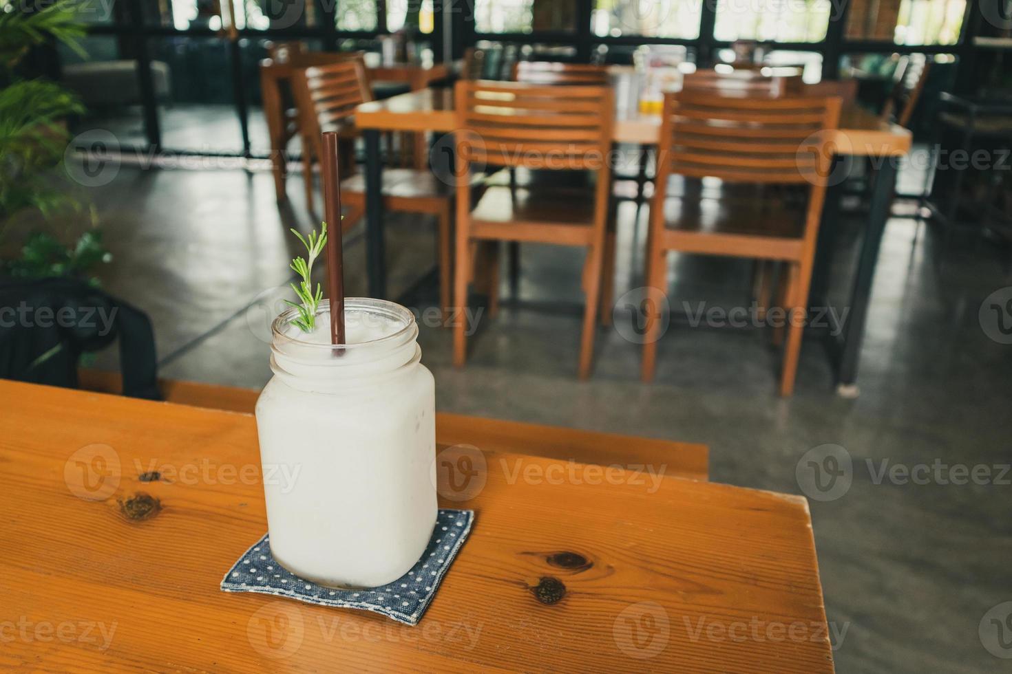 coconut water frappe with rosemary leaf on restaurant table photo