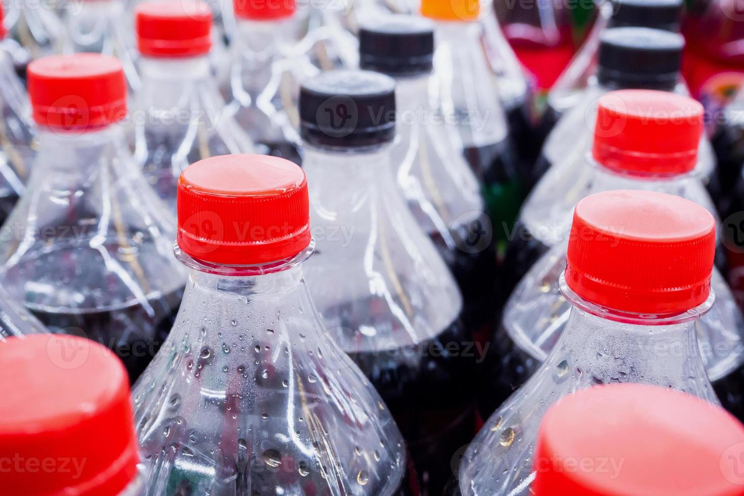 Carbonated soft drink bottles close up photo