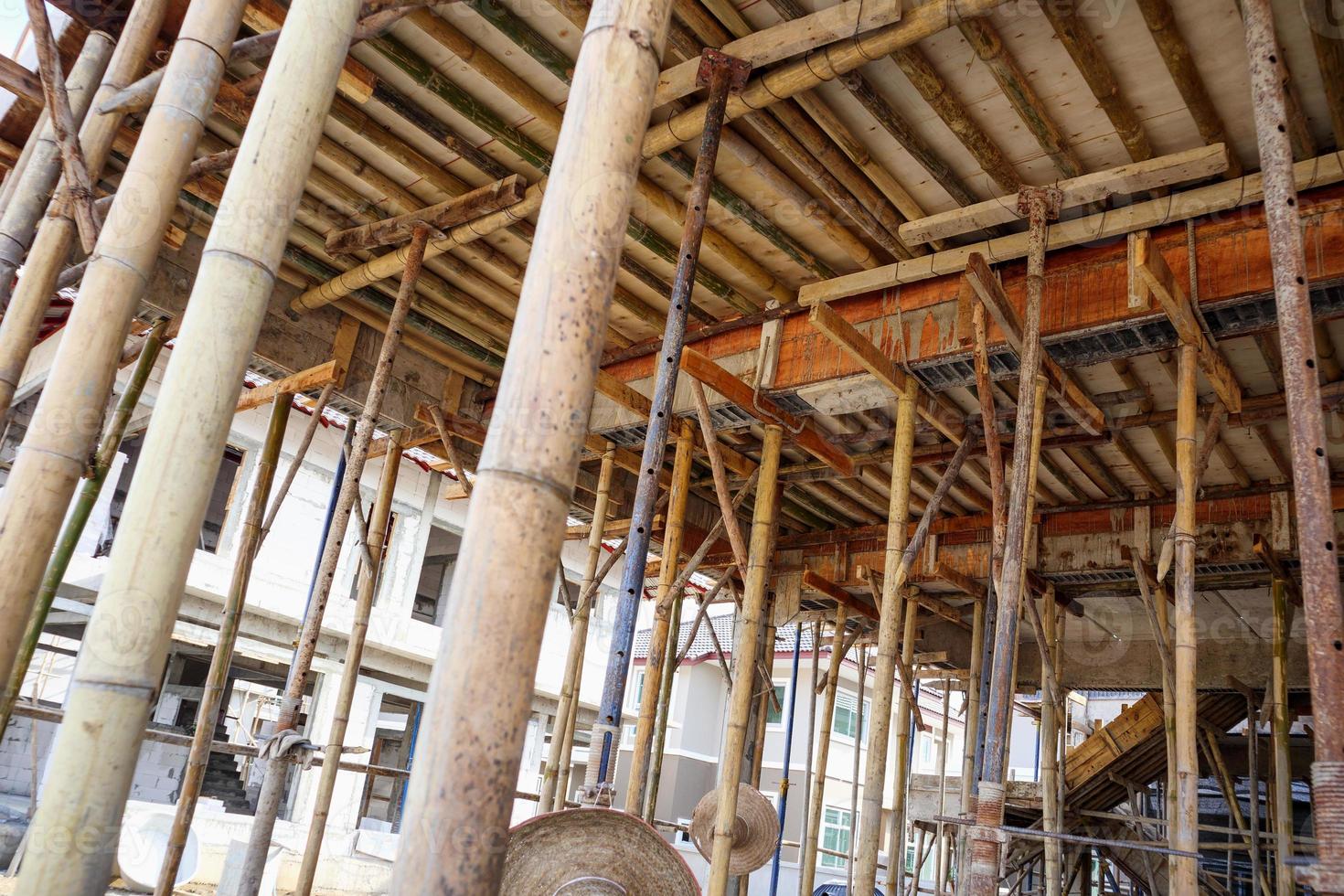 Bamboo scaffolding support concrete beam at house construction site photo