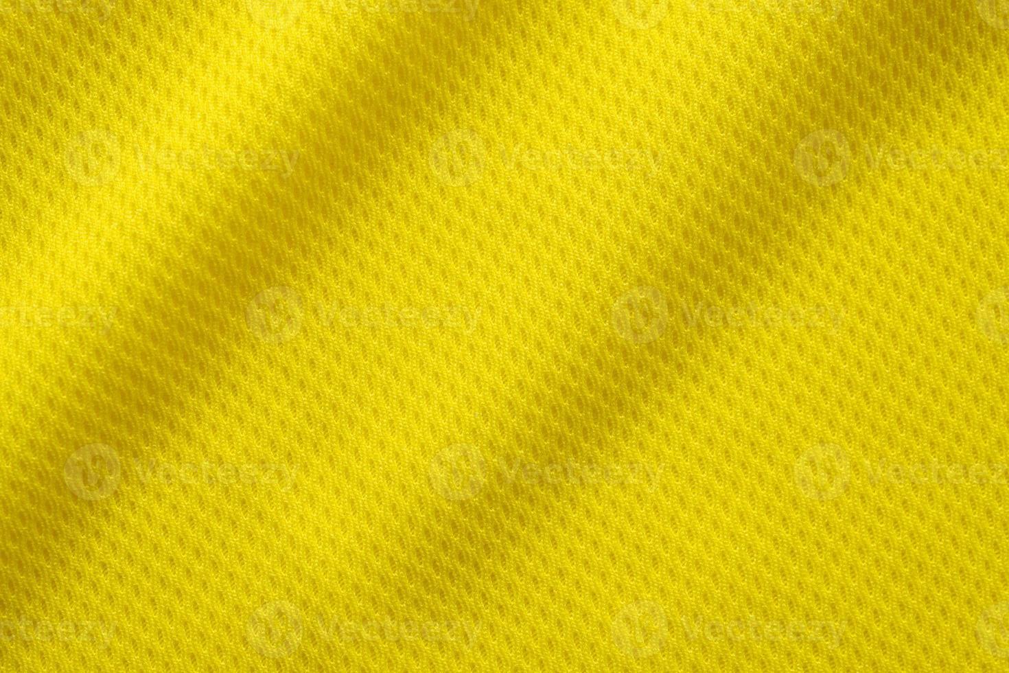 Yellow color football jersey clothing fabric texture sports wear background, close up photo