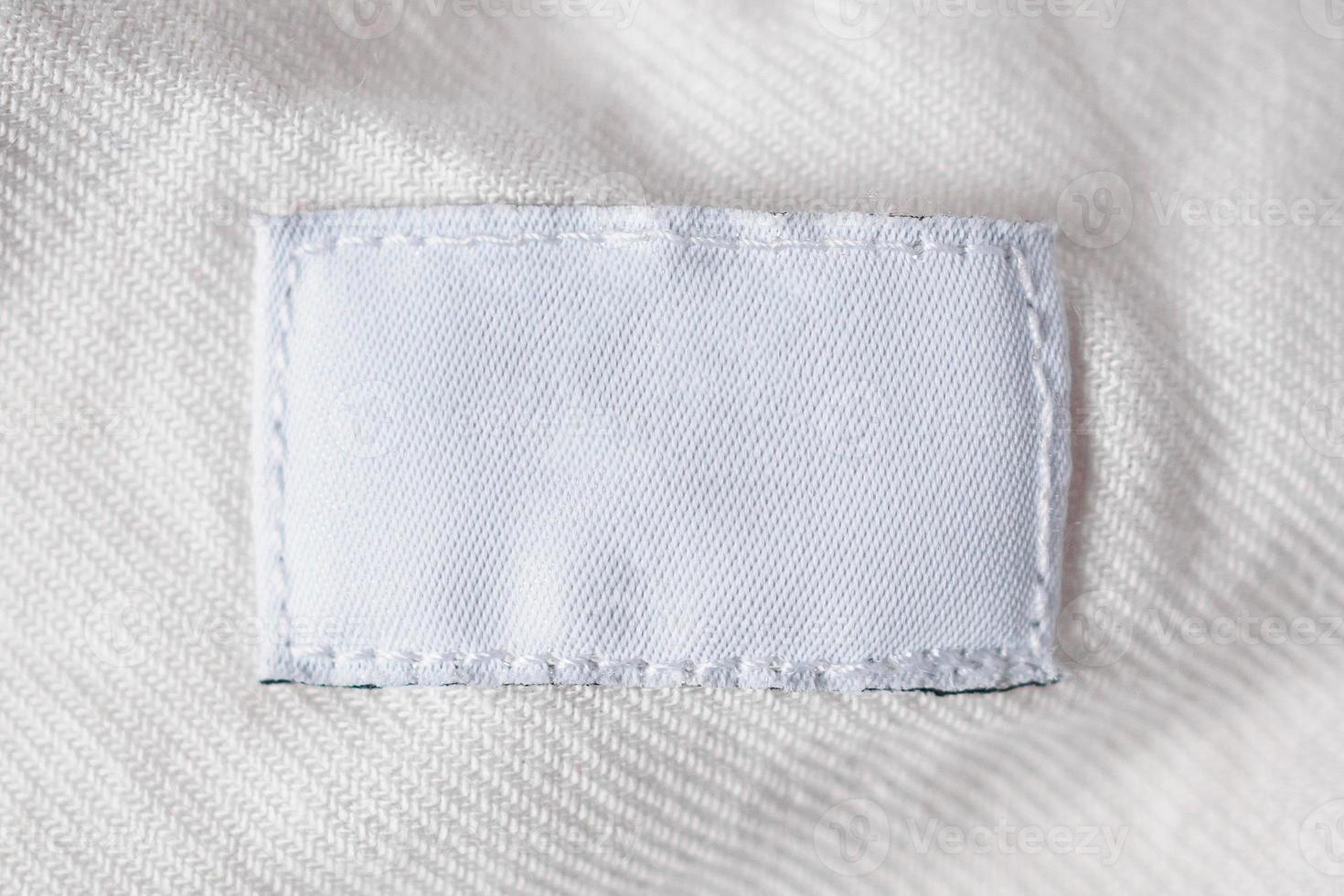 White blank laundry care clothes label on cotton shirt photo