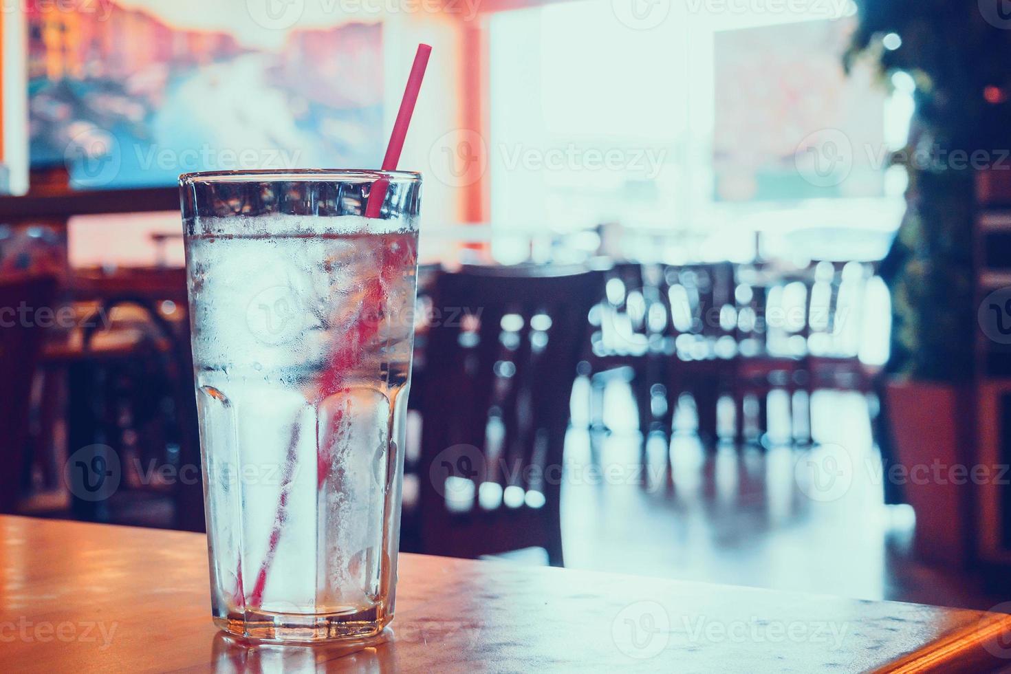 glass of water on wood table in restaurant photo