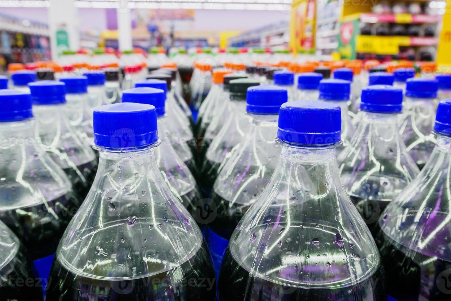 Carbonated soft drink bottles close up photo