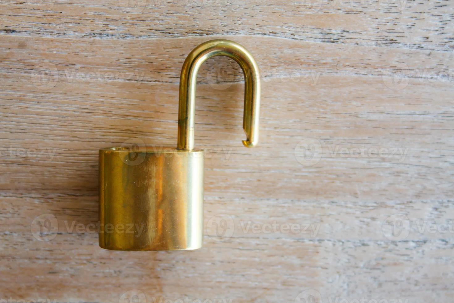Golden padlock on wood background photo