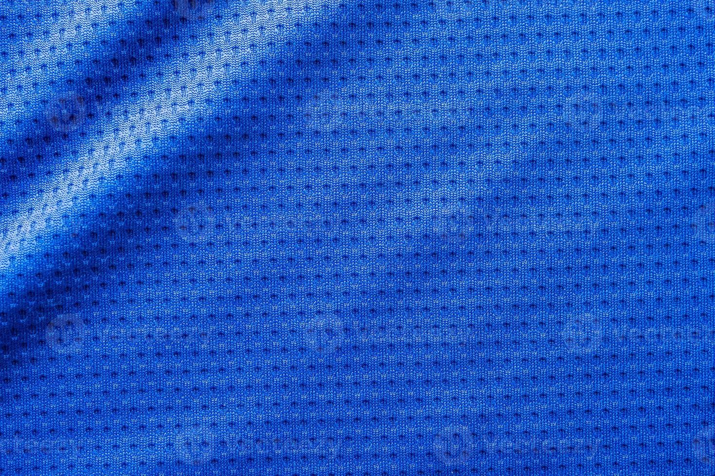 Blue color fabric sport clothing football jersey with air mesh texture background photo