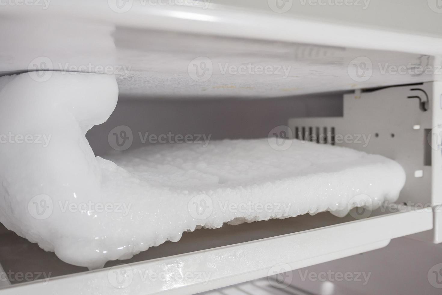 frozen Ice buildup in the freezer of refrigerator photo