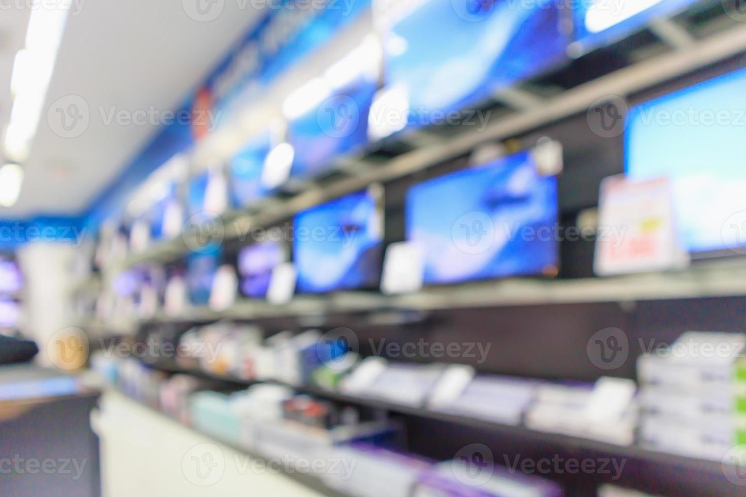 Los grandes almacenes electrónicos muestran televisión y electrodomésticos con fondo borroso de luz bokeh foto