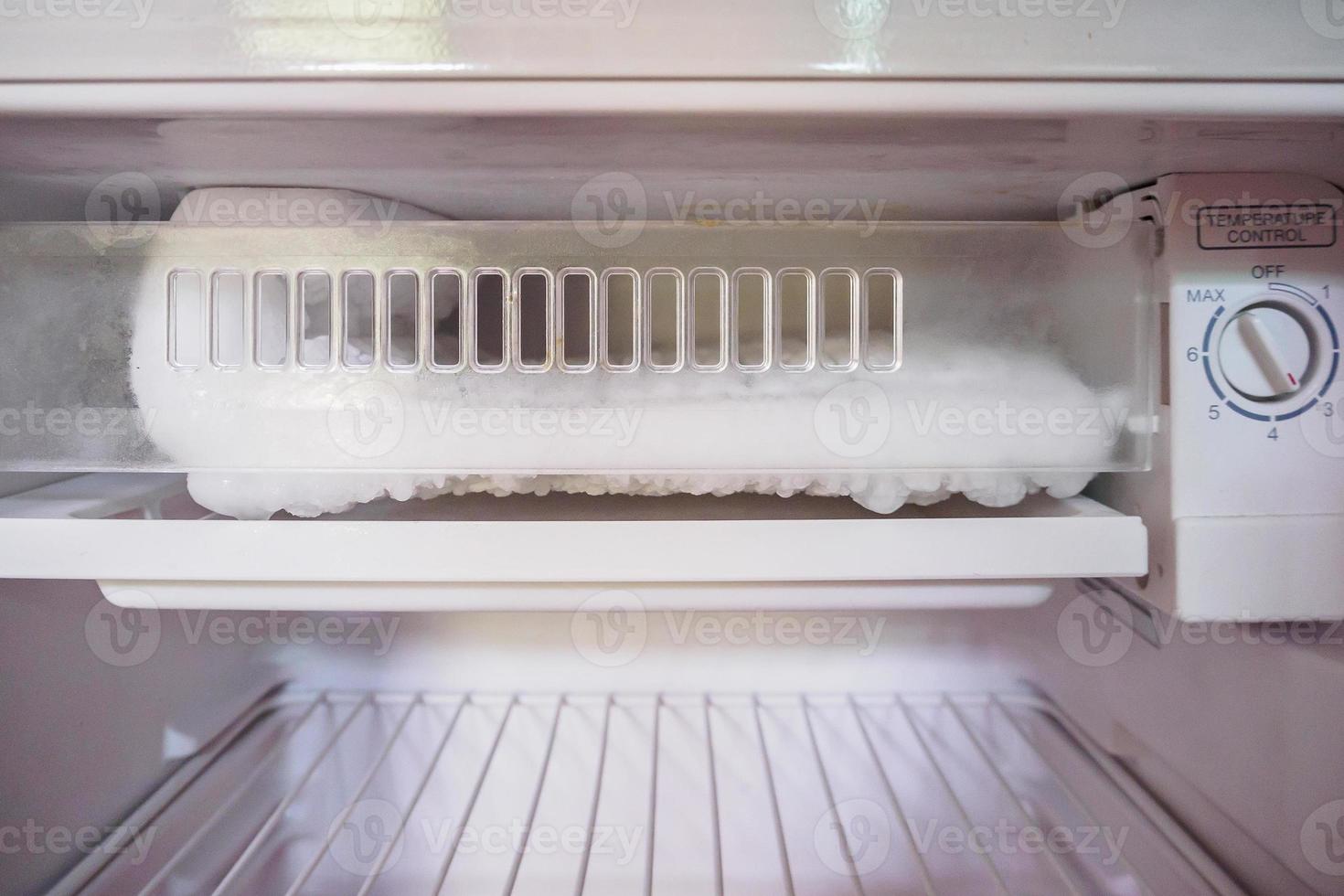 frozen Ice buildup in the freezer of refrigerator photo