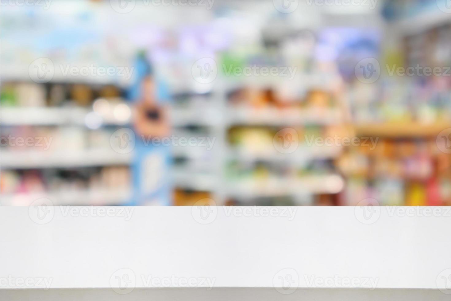 Pharmacy drugstore counter table with blur abstract backbround with medicine and healthcare product on shelves photo