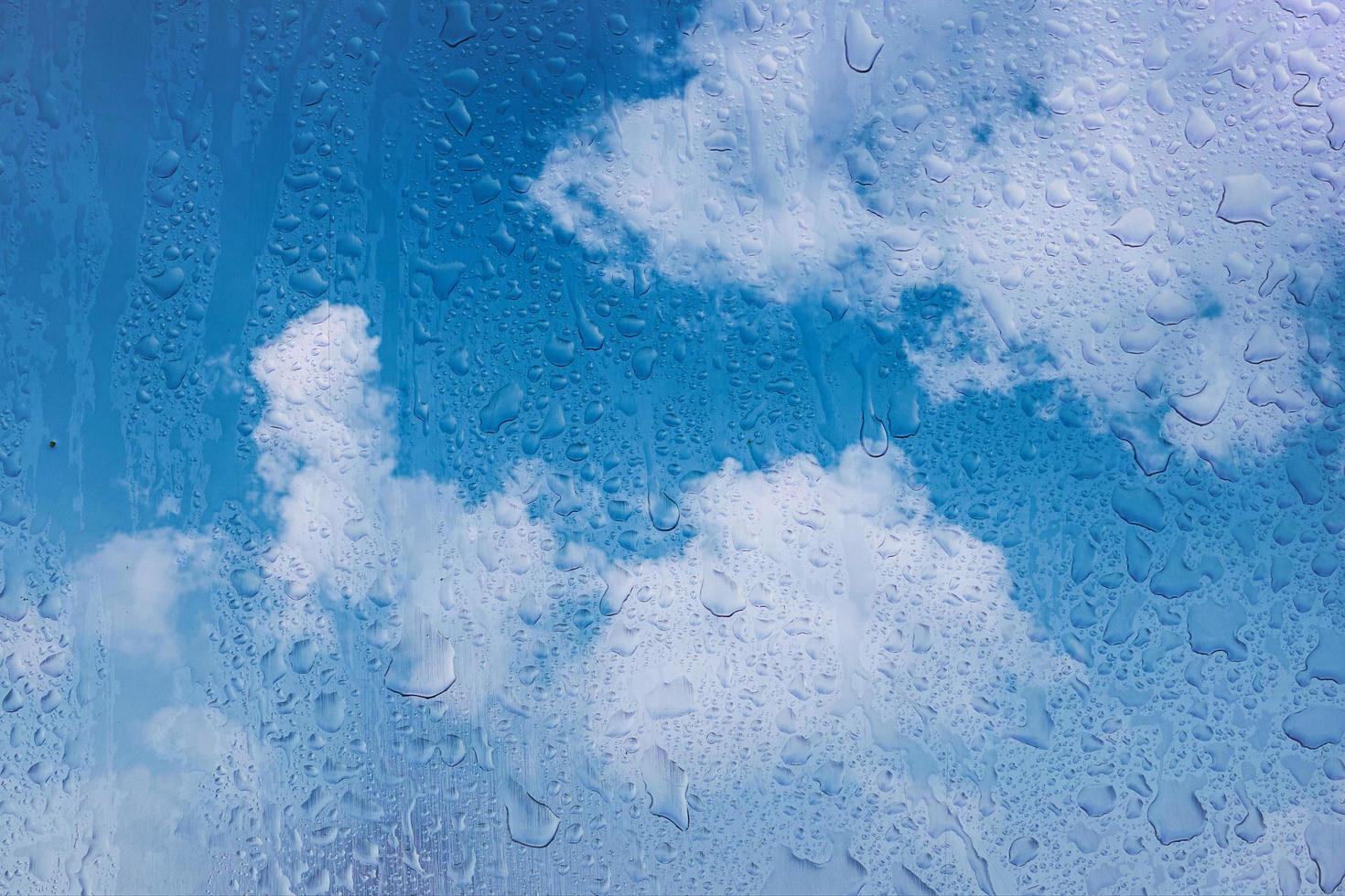 drops on the window and blue sky backgroun photo