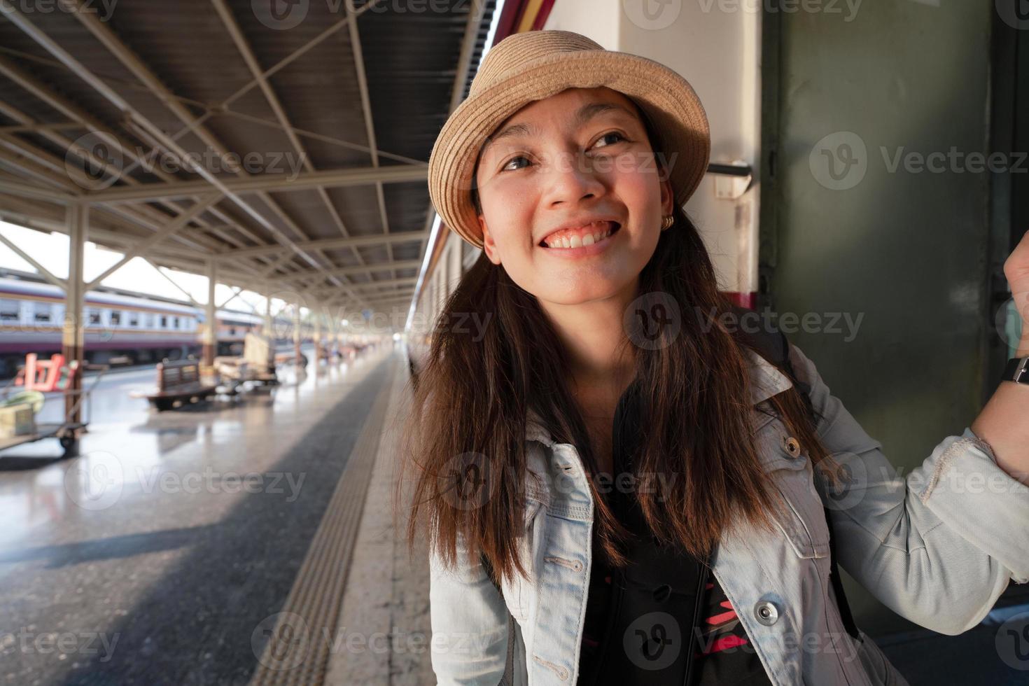 Happy Asian woman travel by traditional train in Thailand photo