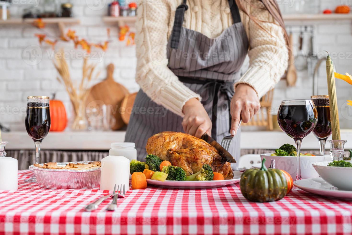 woman preparing thanksgiving dinner at home kitchen, decorating photo