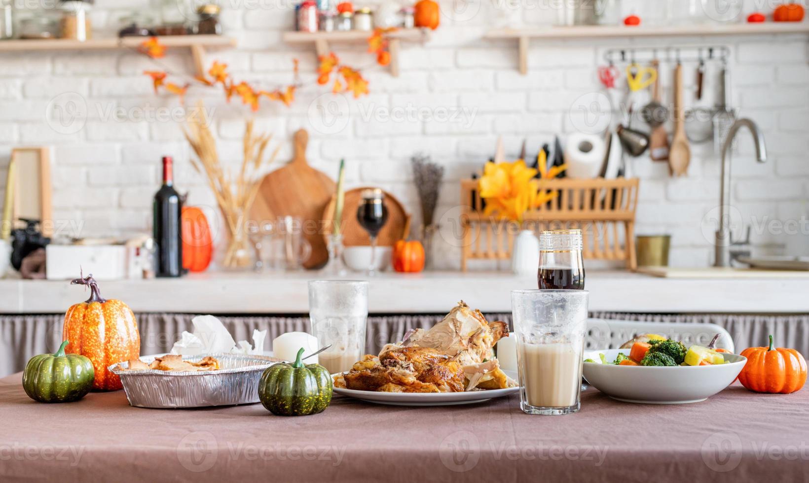 front view of thanksgiving table after feast, leftovers and dirty dishes photo