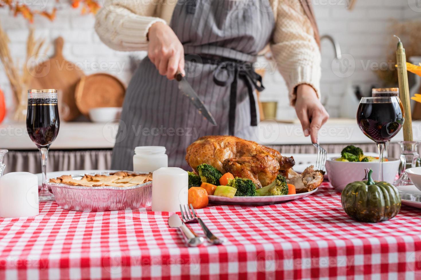 woman preparing thanksgiving dinner at home kitchen, decorating photo