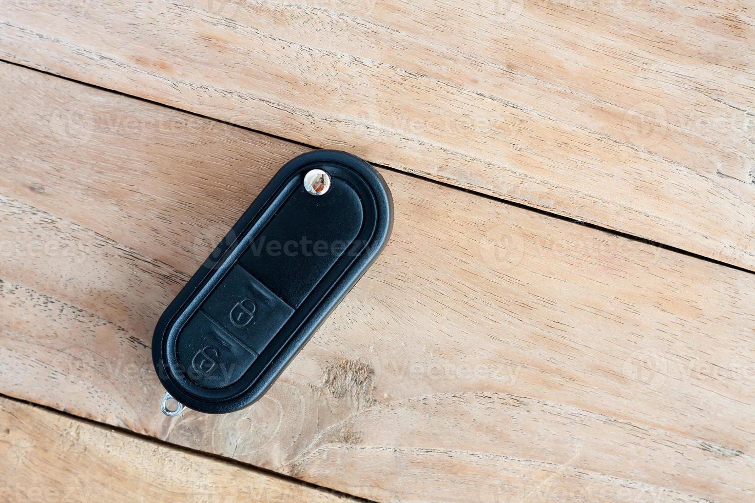 Car Key on old wood table background photo