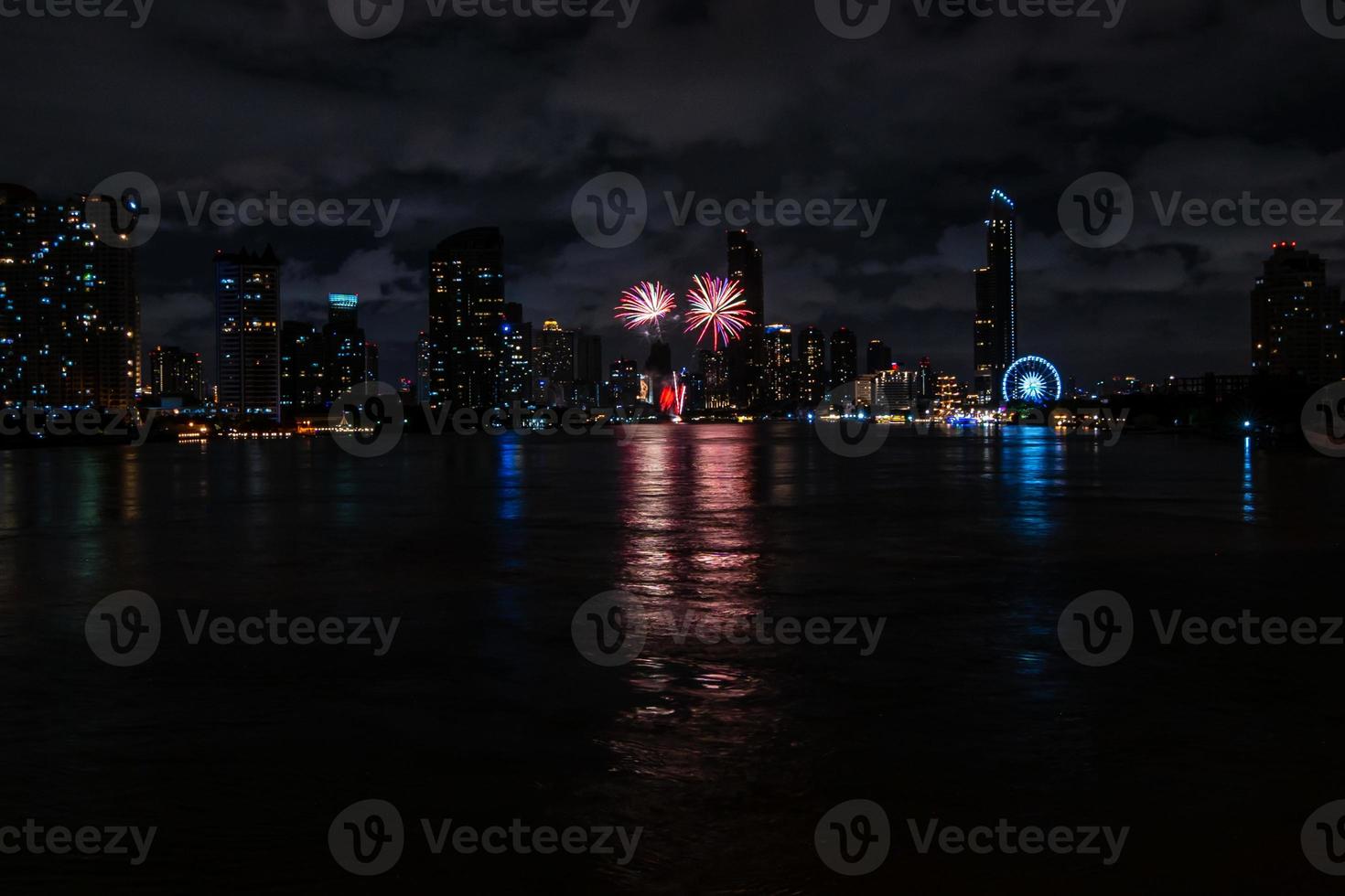 fireworks on the river in the dark sky photo