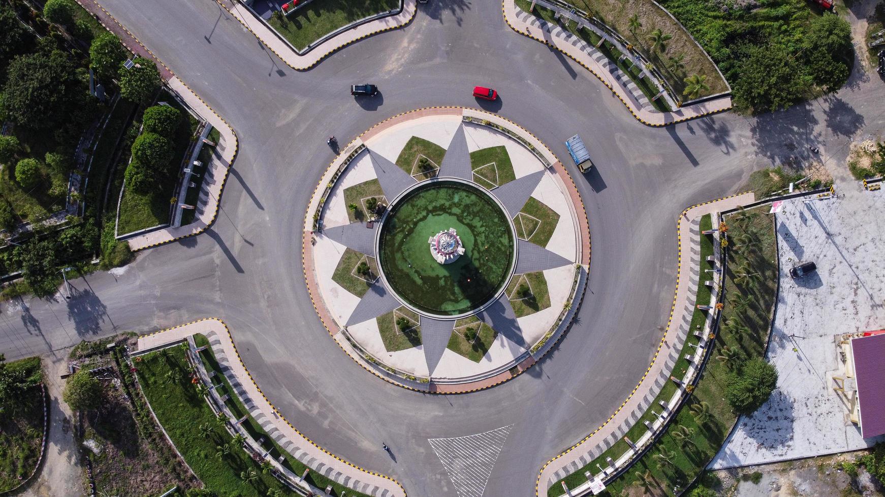 Pasangkayu, West Sulawesi, Indonesia, 2020 - Aerial view of Bundaran Smart in Pasangkayu regency, Indonesia with Tugu Smart.  City roundabout view with city monument. photo