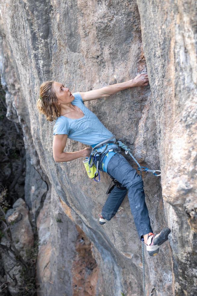 The sports girl is engaged in rock climbing photo