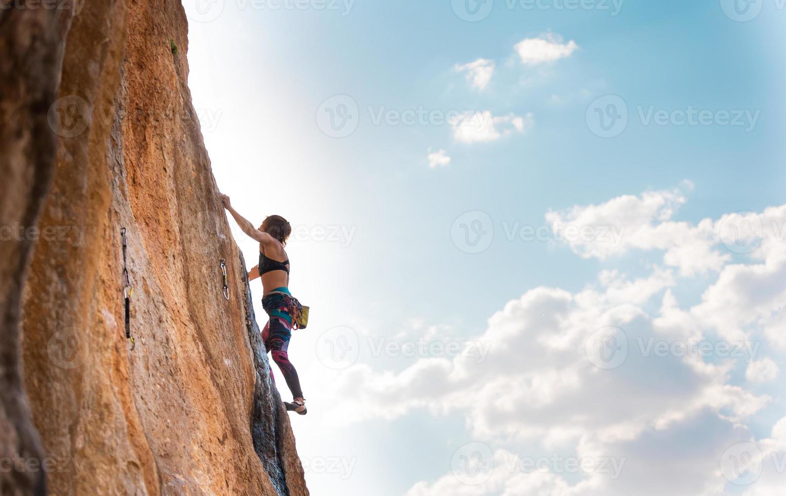 The sports girl is engaged in rock climbing photo