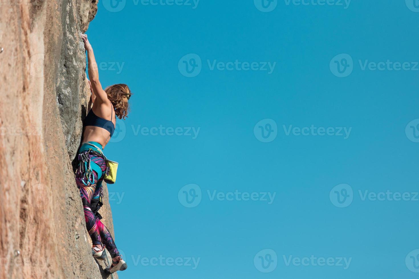 The sports girl is engaged in rock climbing photo